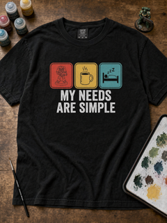 Close-up of 'My Needs Are Simple' tee graphic with minis, coffee and sleep icons in red, gold and teal — view 2